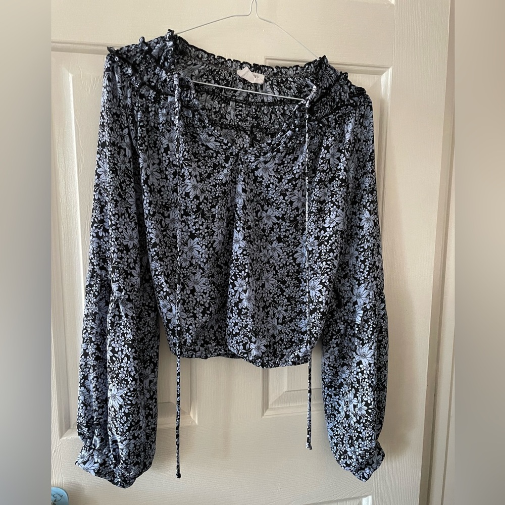 Cute black top with blue flowers with elastic waist.